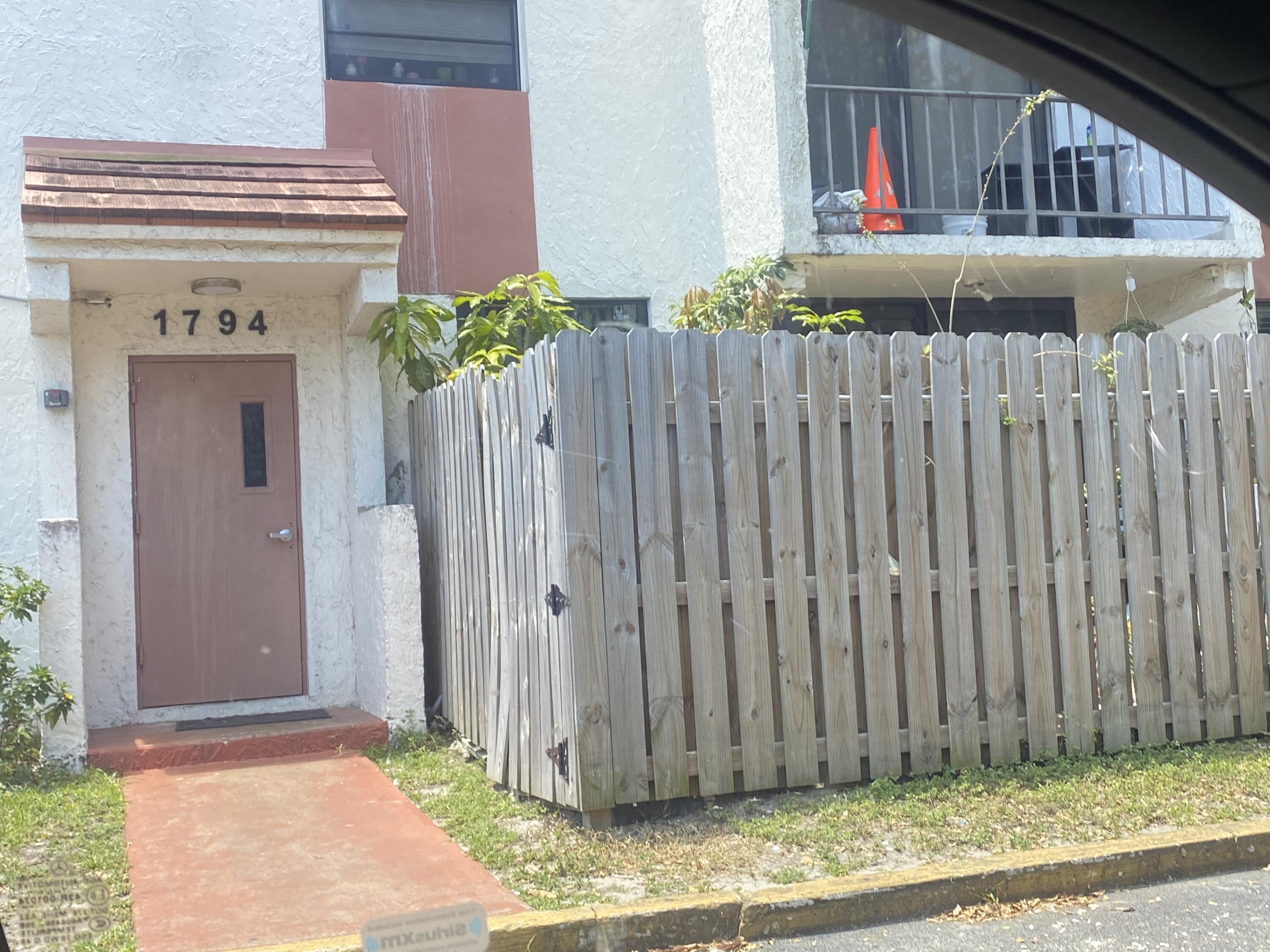 a view of a house with wooden fence