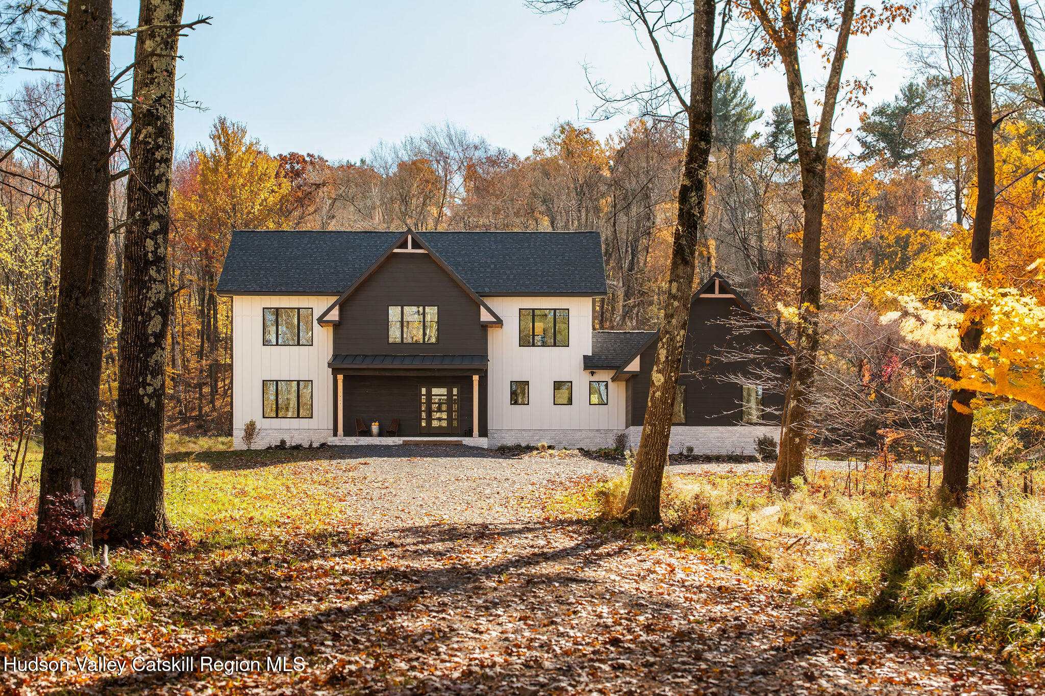 a view of a house with trees in the background