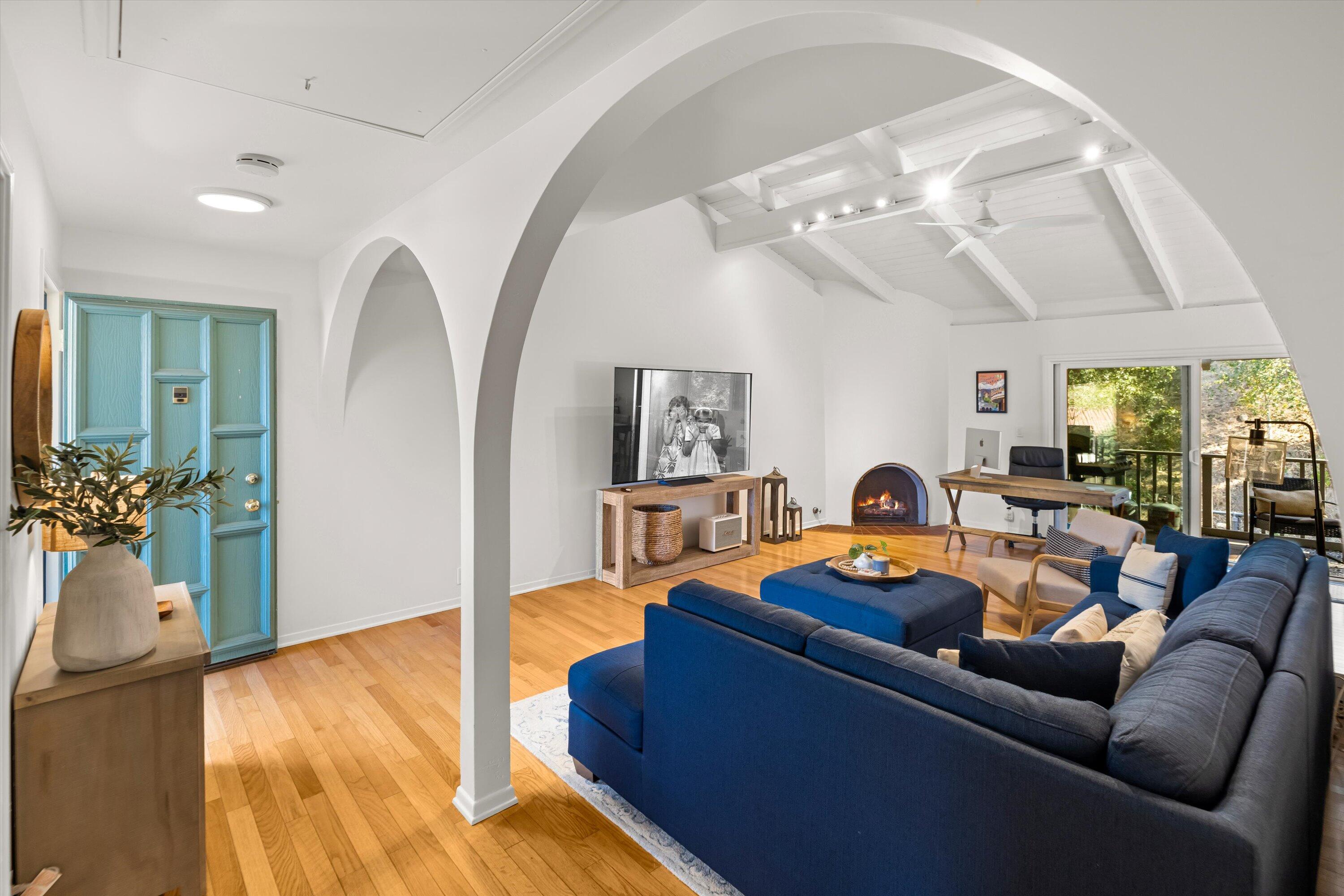 a living room with furniture and wooden floor