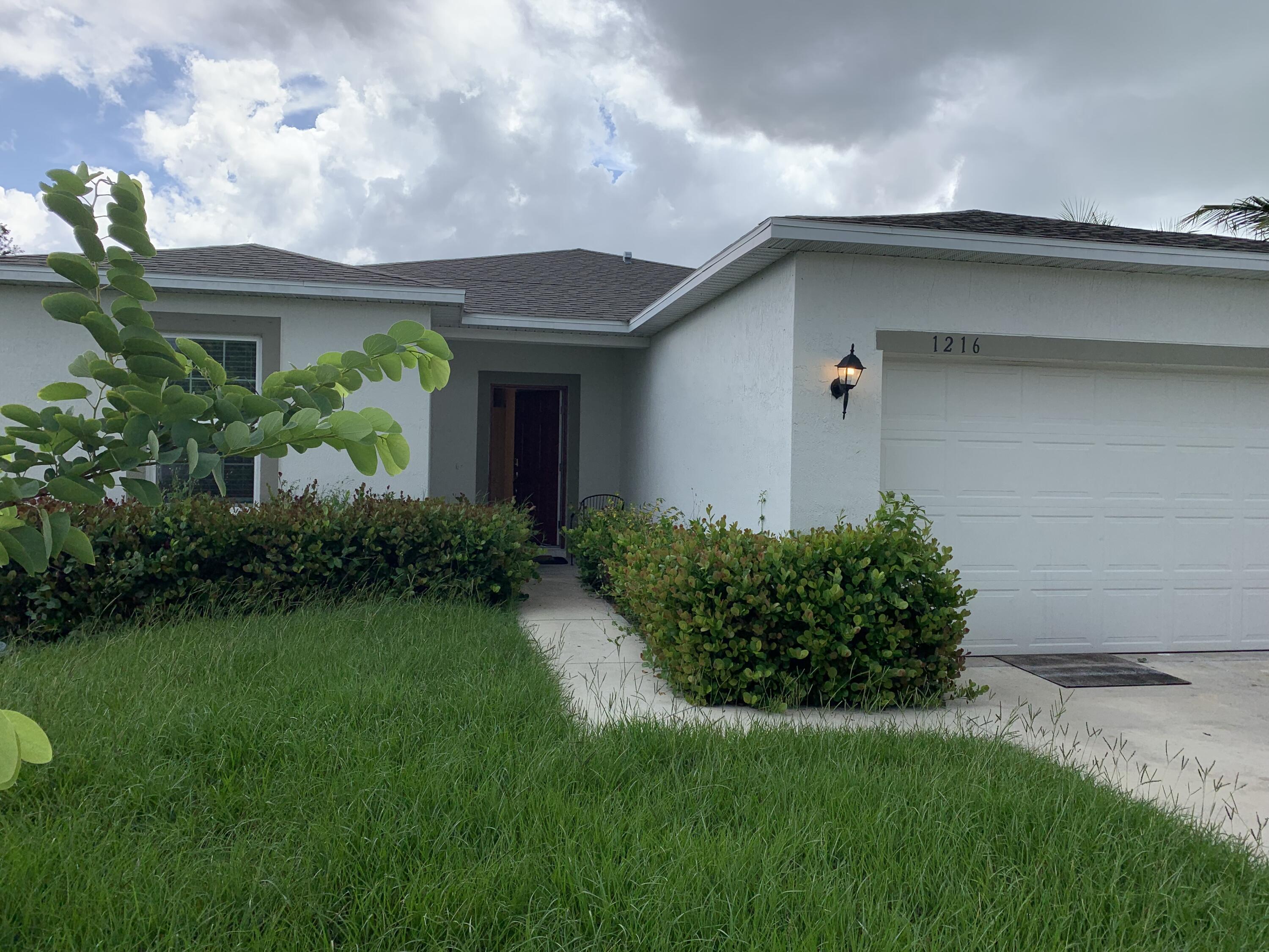 a front view of house with garden