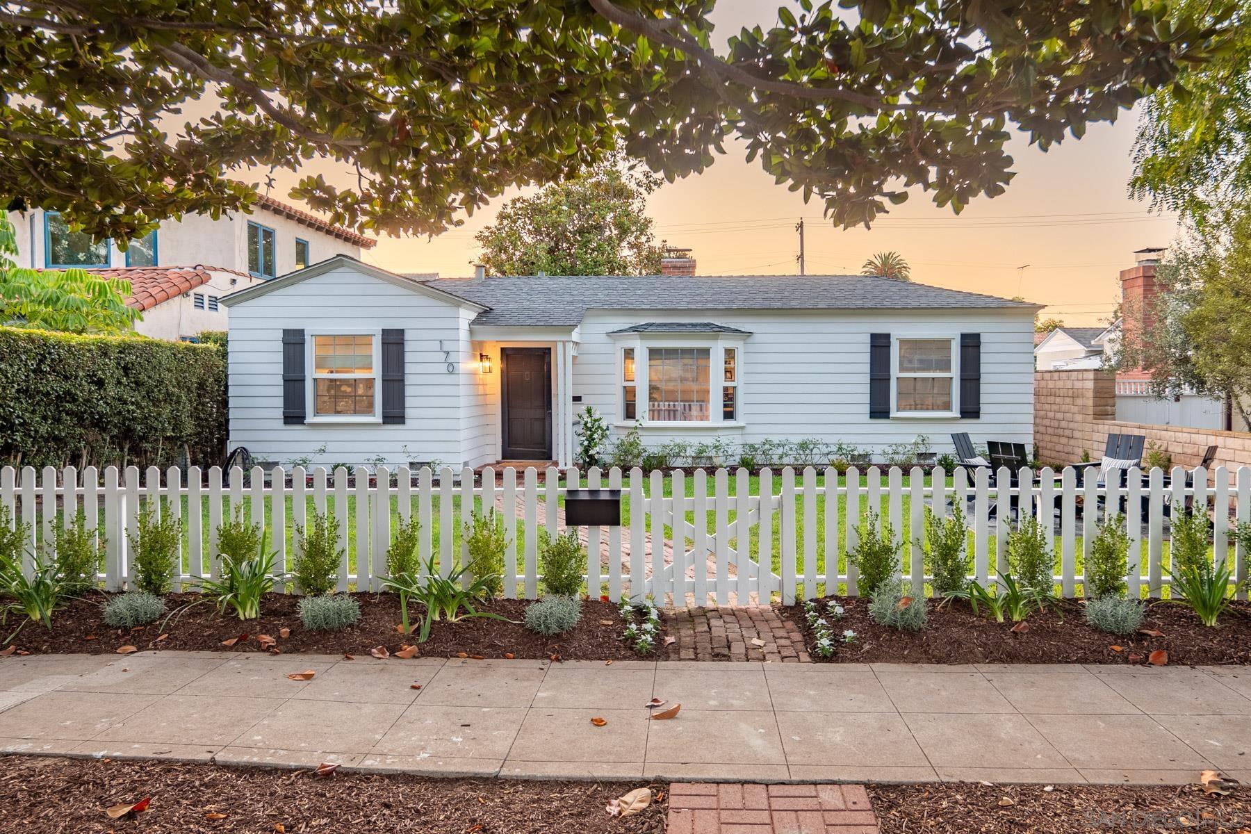 a front view of a house with a garden