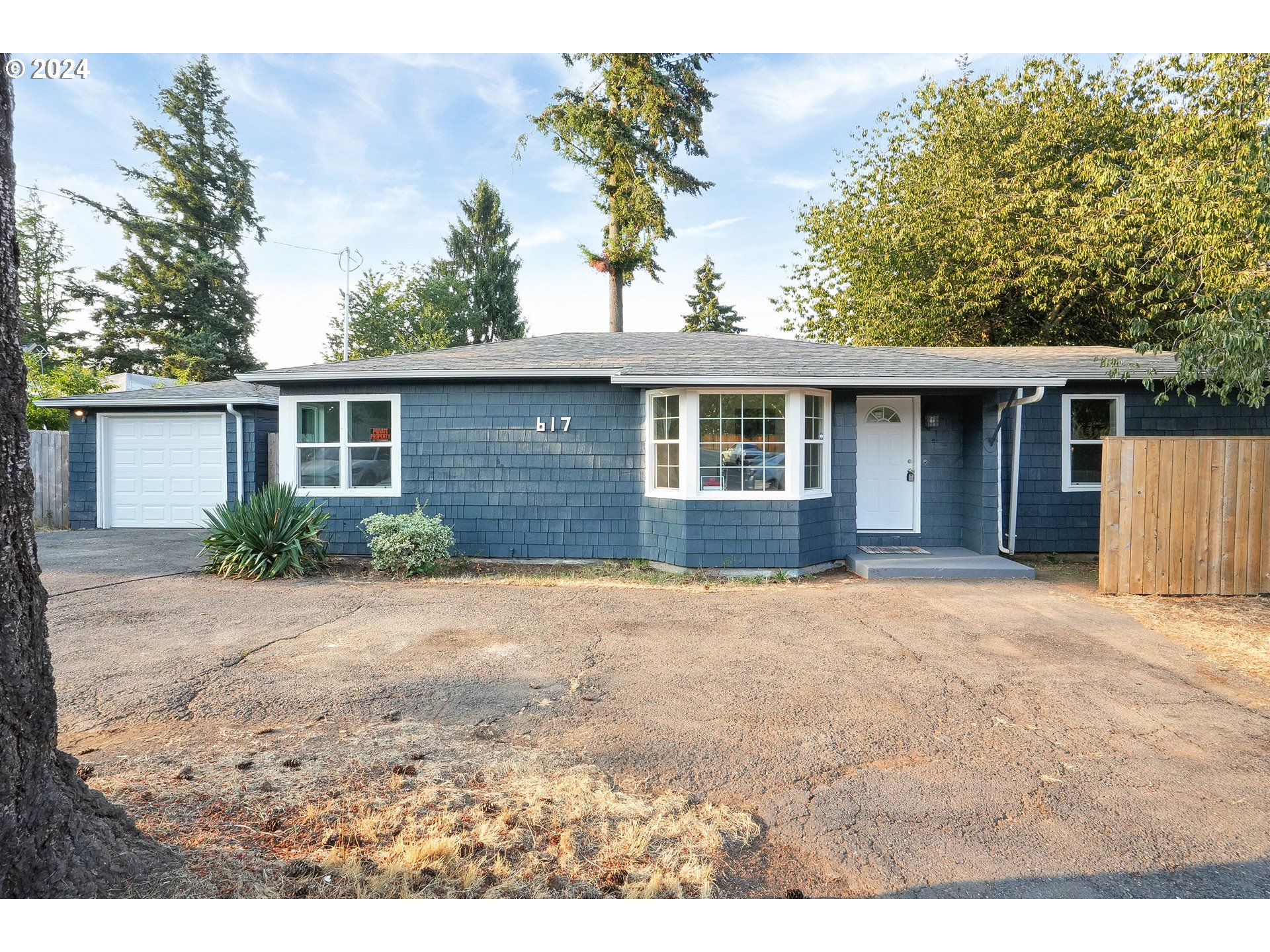 a front view of a house with a yard and a garage