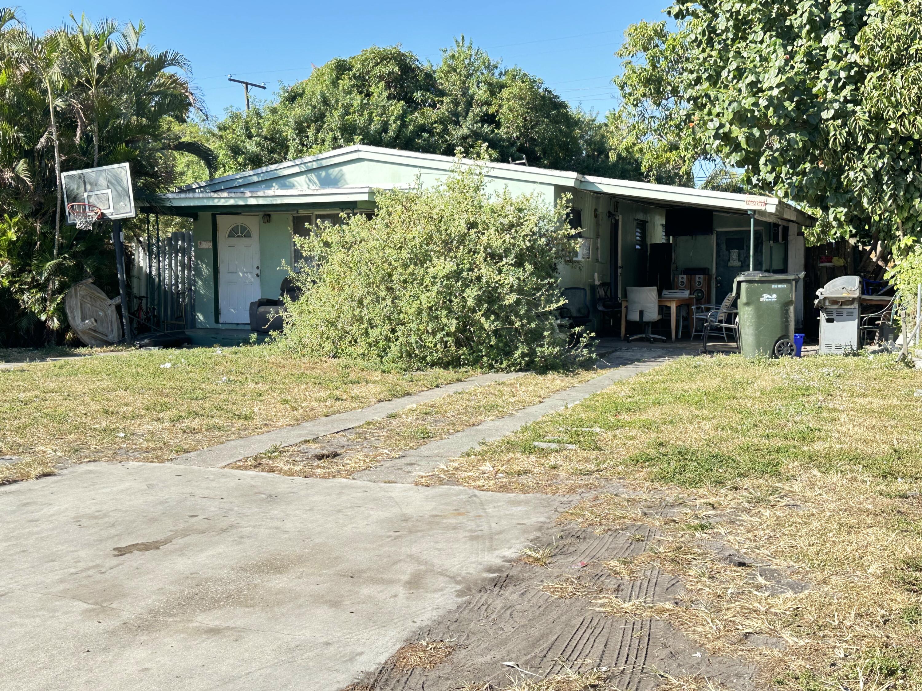 a view of a house with floor to ceiling windows and a yard