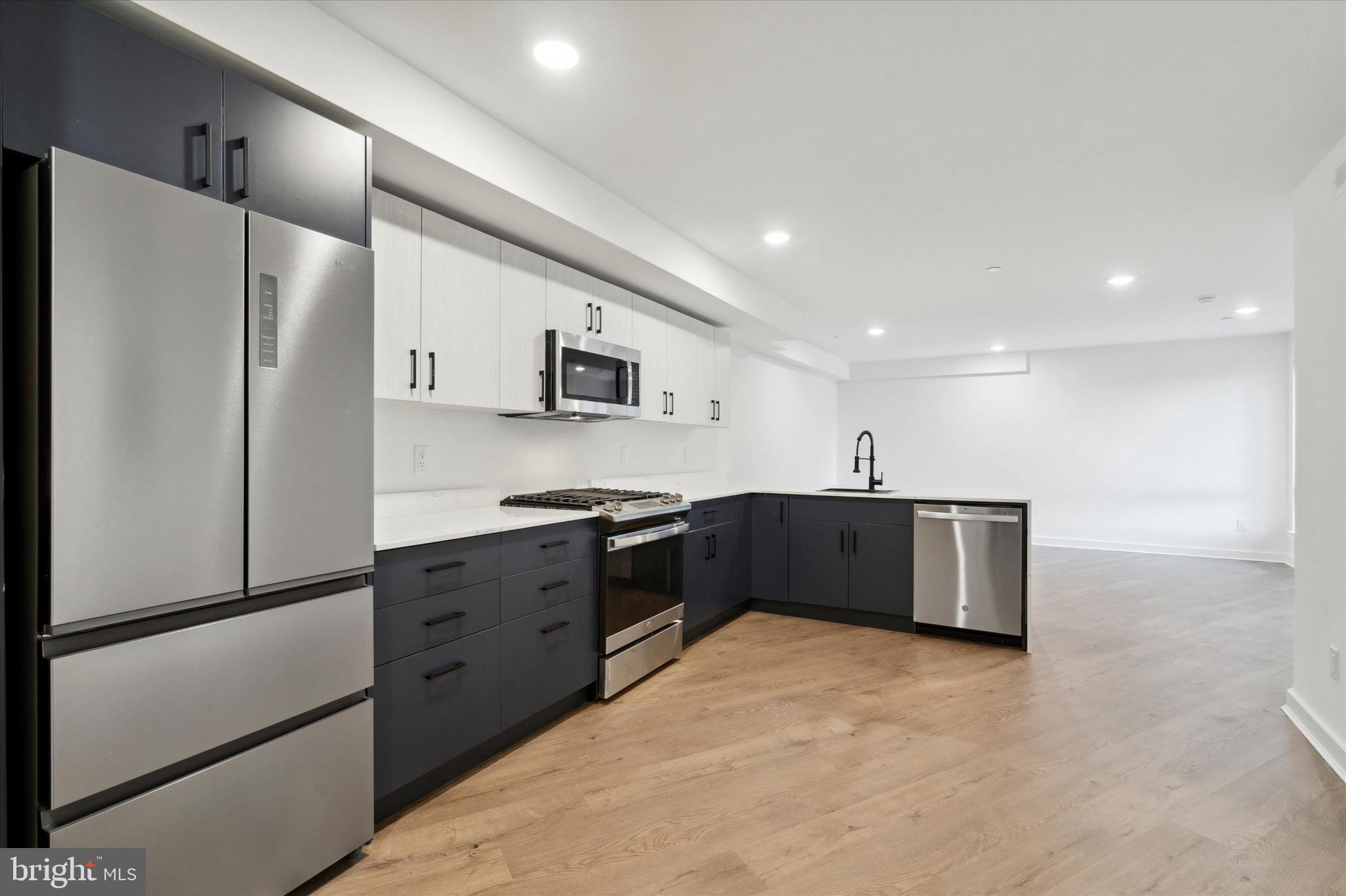 a kitchen with stainless steel appliances a refrigerator and a sink