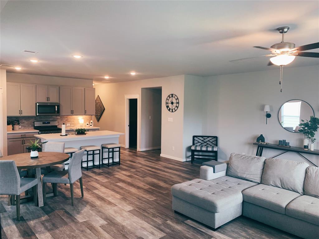 a living room with furniture and wooden floor