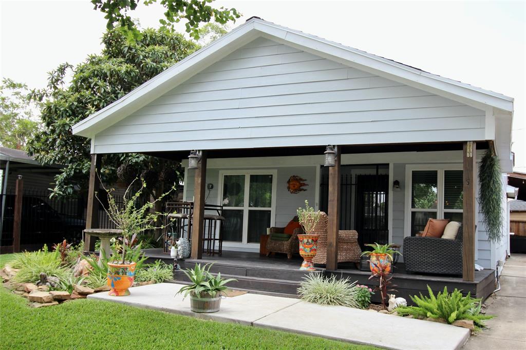 a front view of house with yard and outdoor seating