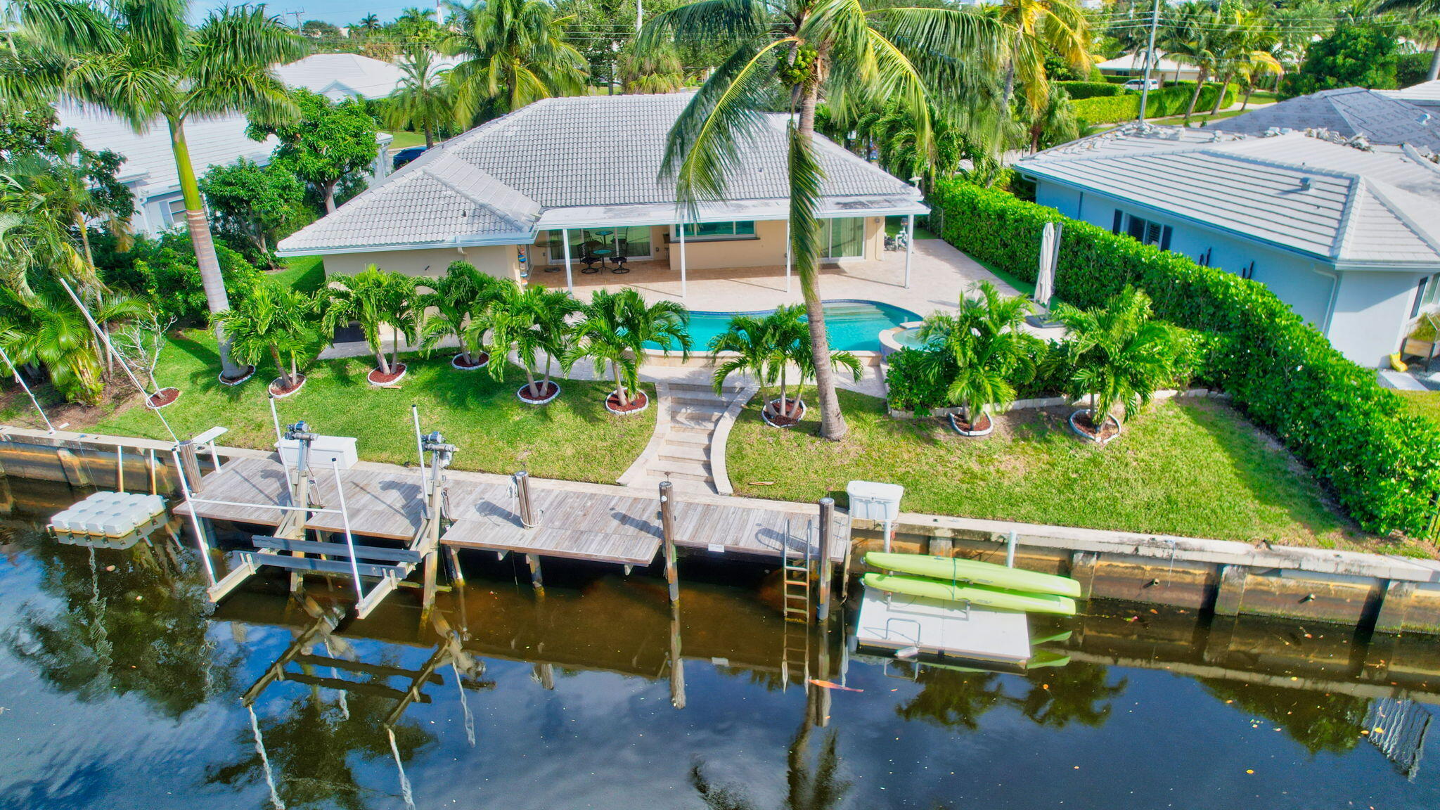 an aerial view of a house with swimming pool and outdoor seating