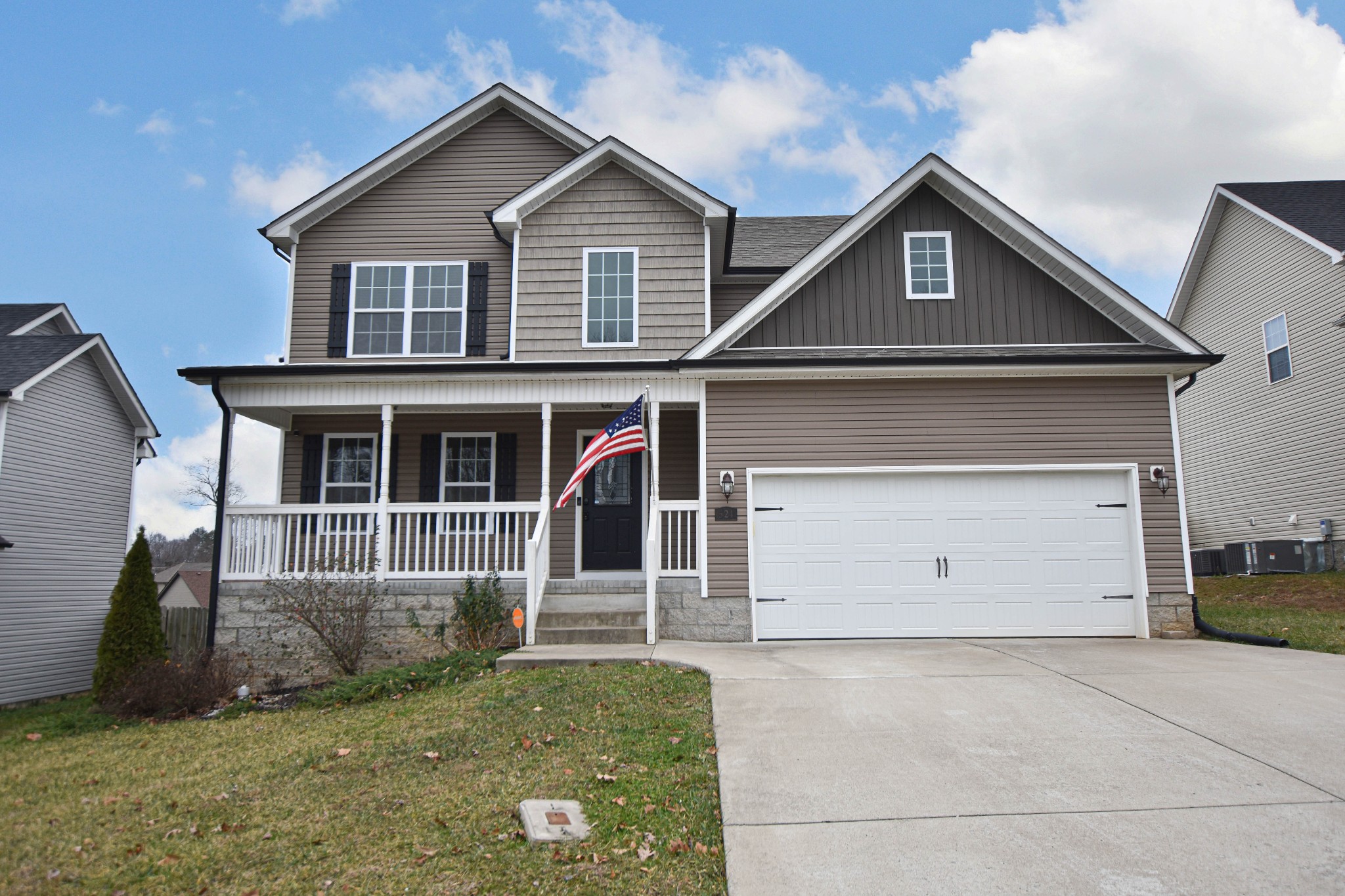 a view of a house with a yard and garage