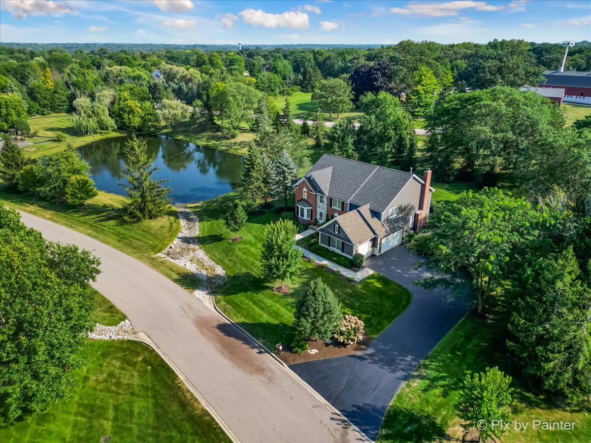 an aerial view of a house with a yard