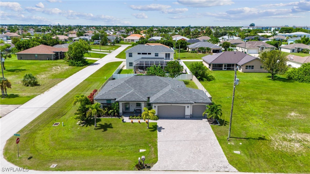 a aerial view of a house with swimming pool and yard