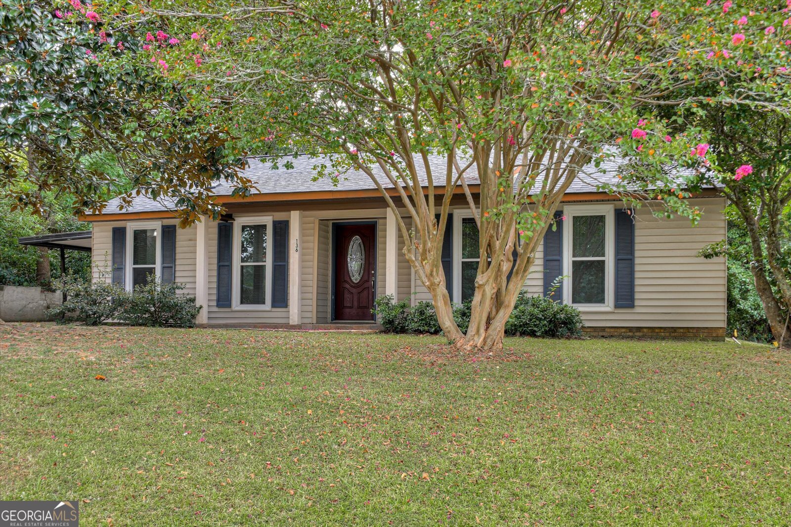 a front view of a house with a garden