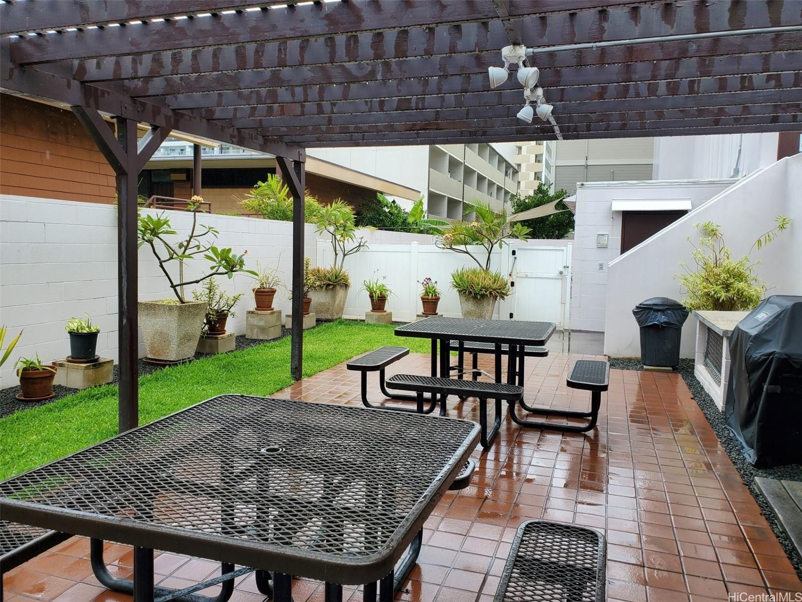 a view of a patio with table and chairs potted plants with wooden floor