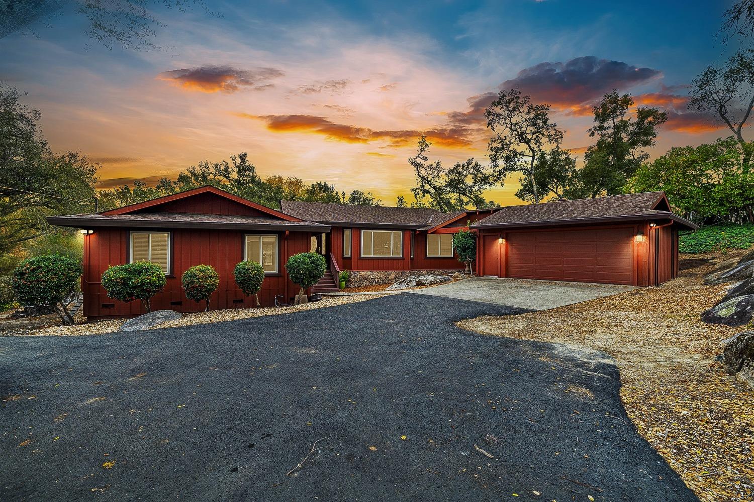 a front view of a house with yard garage