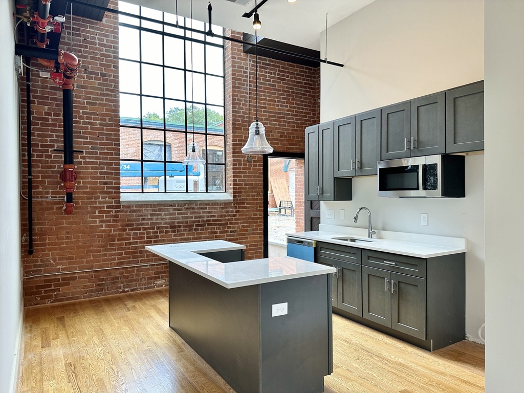 a kitchen with stainless steel appliances a sink stove and cabinets