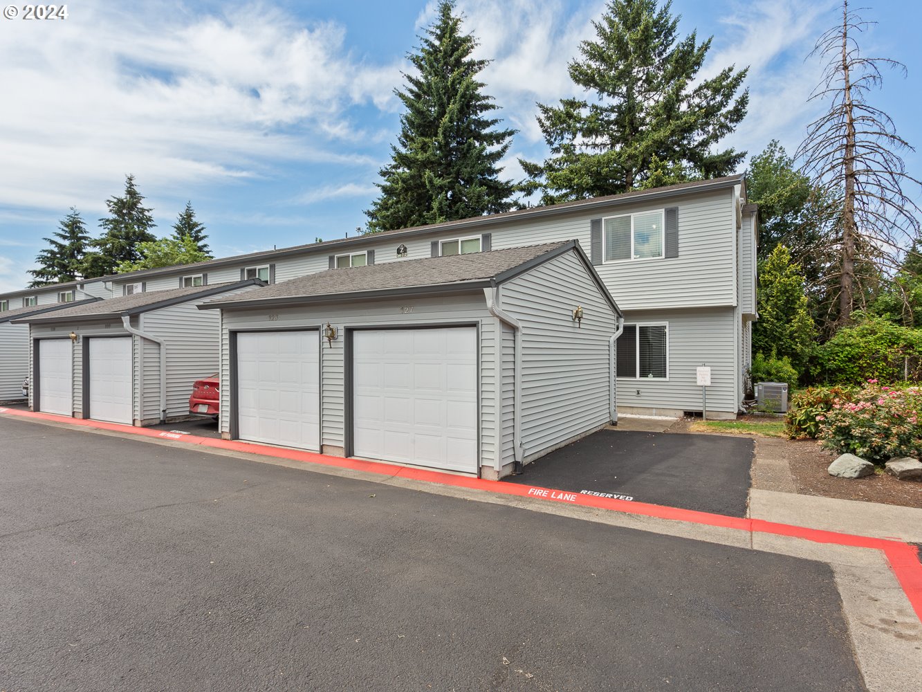 a view of a house with a garage and yard