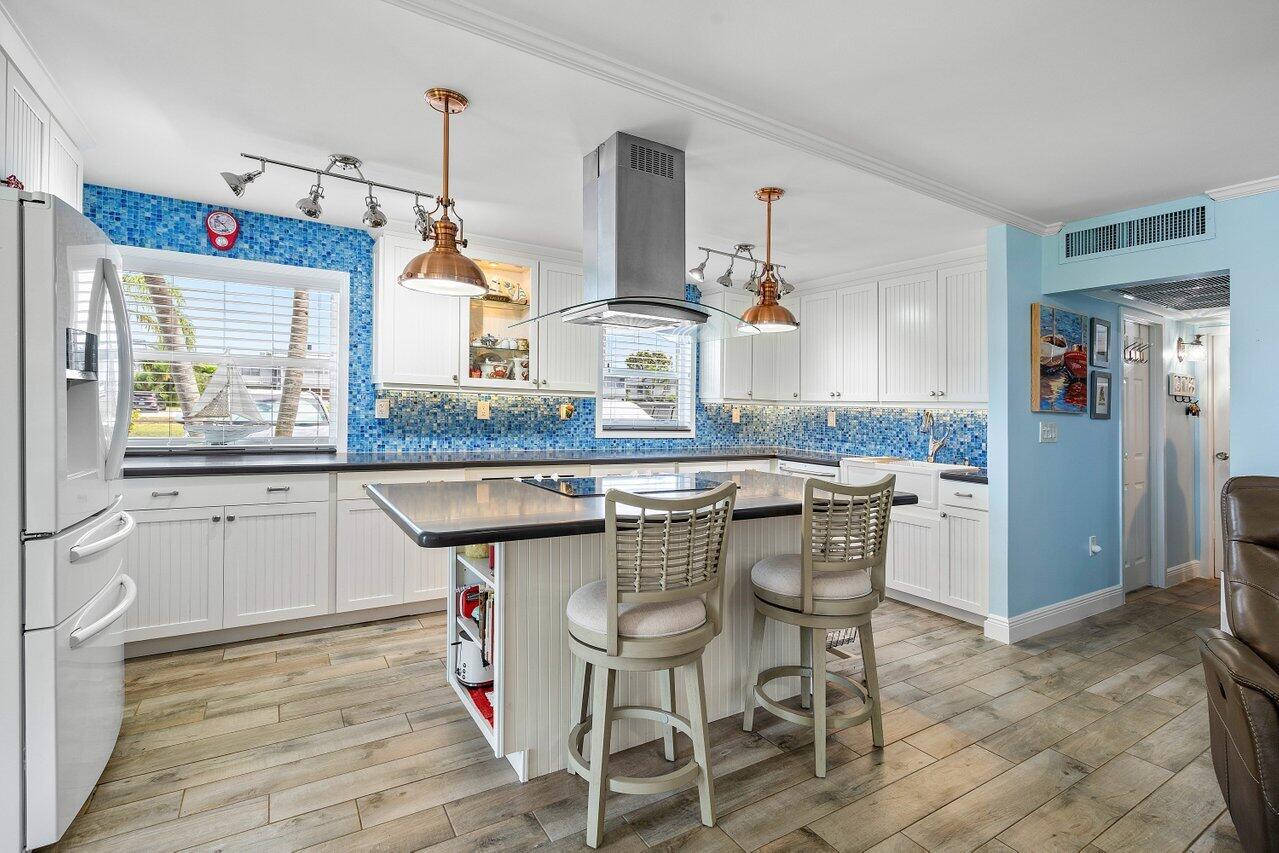 a kitchen with granite countertop counter space a sink appliances and cabinets