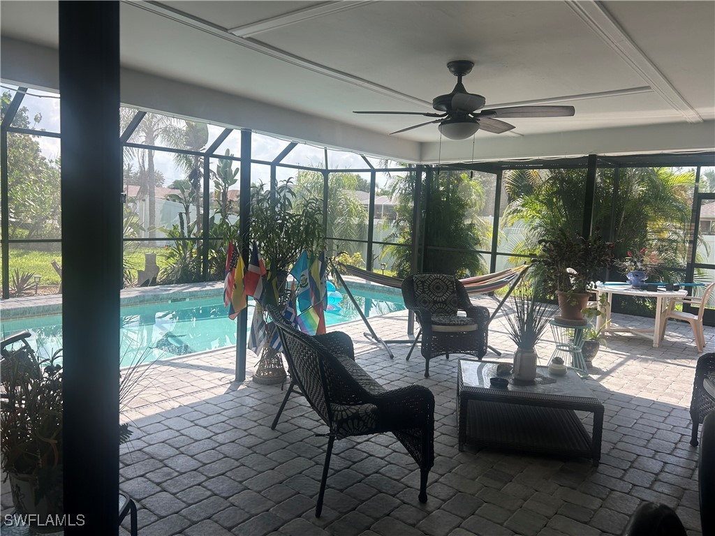 a dining room with furniture water view and a floor to ceiling window