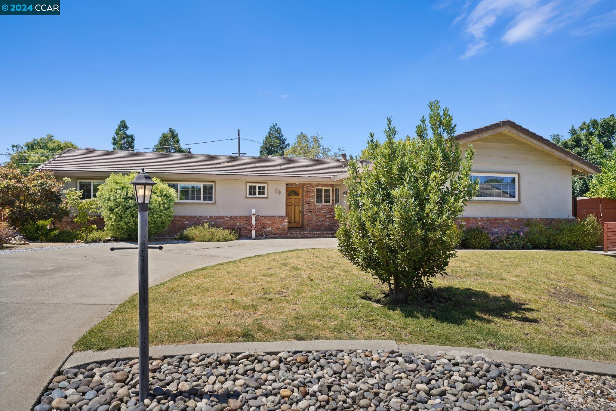 a front view of a house with garden