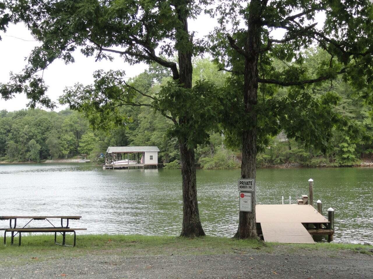 a lake view with a bench and trees