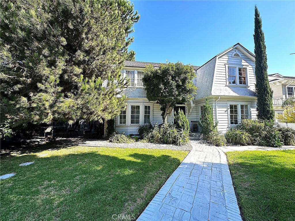 a view of a house with a yard patio and a yard