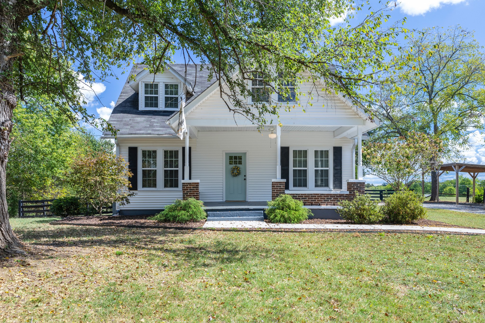 a front view of a house with garden