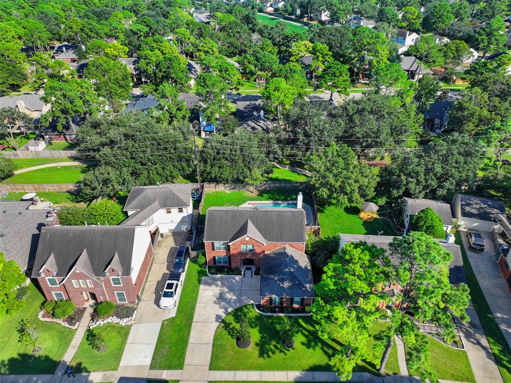 an aerial view of a house with garden space and outdoor seating