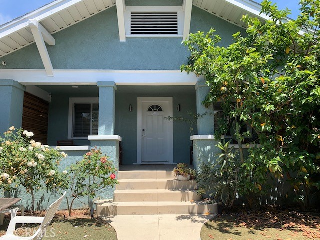 a front view of a house with trees