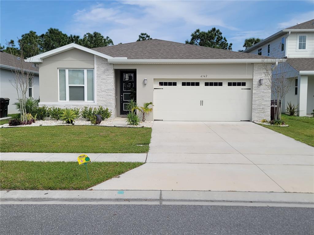 a view of a house with a yard and garage