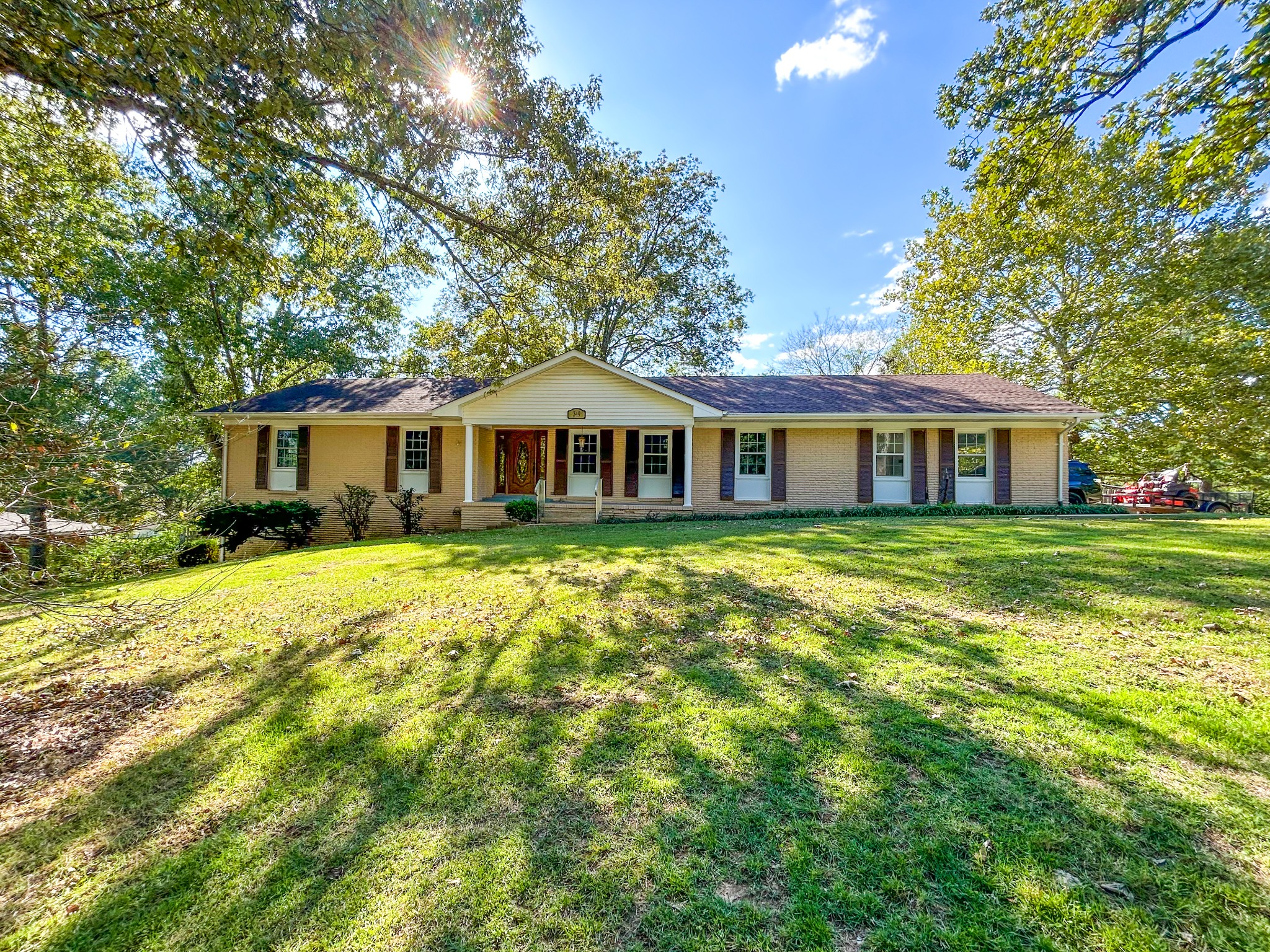 a front view of house with yard and green space