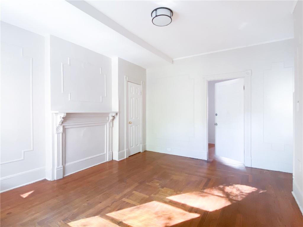 Unfurnished room featuring dark hardwood / wood-style floors