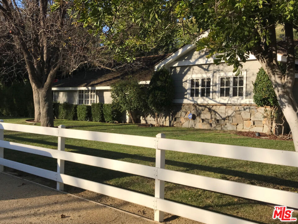 a view of house with yard