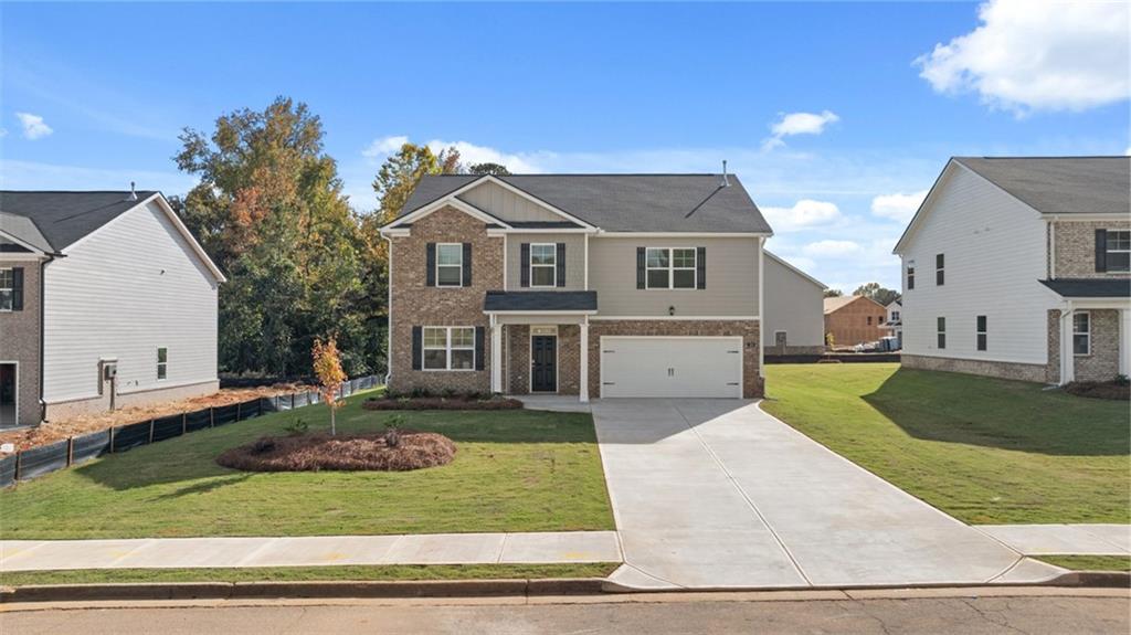 a front view of a house with a yard