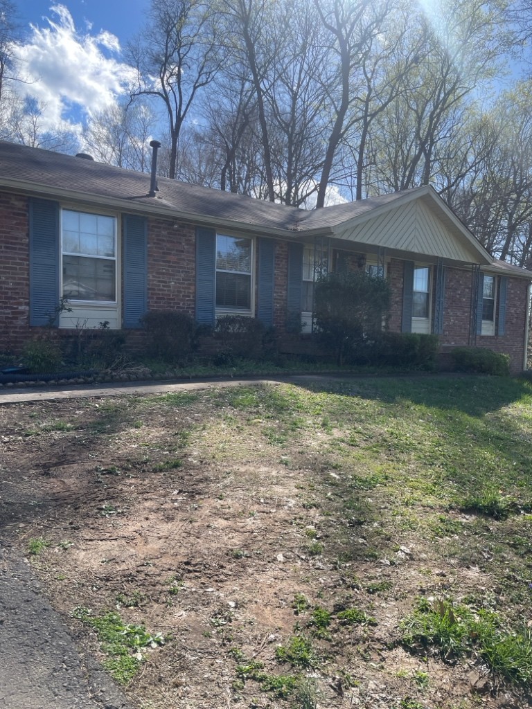 a front view of a house with a yard and a garage