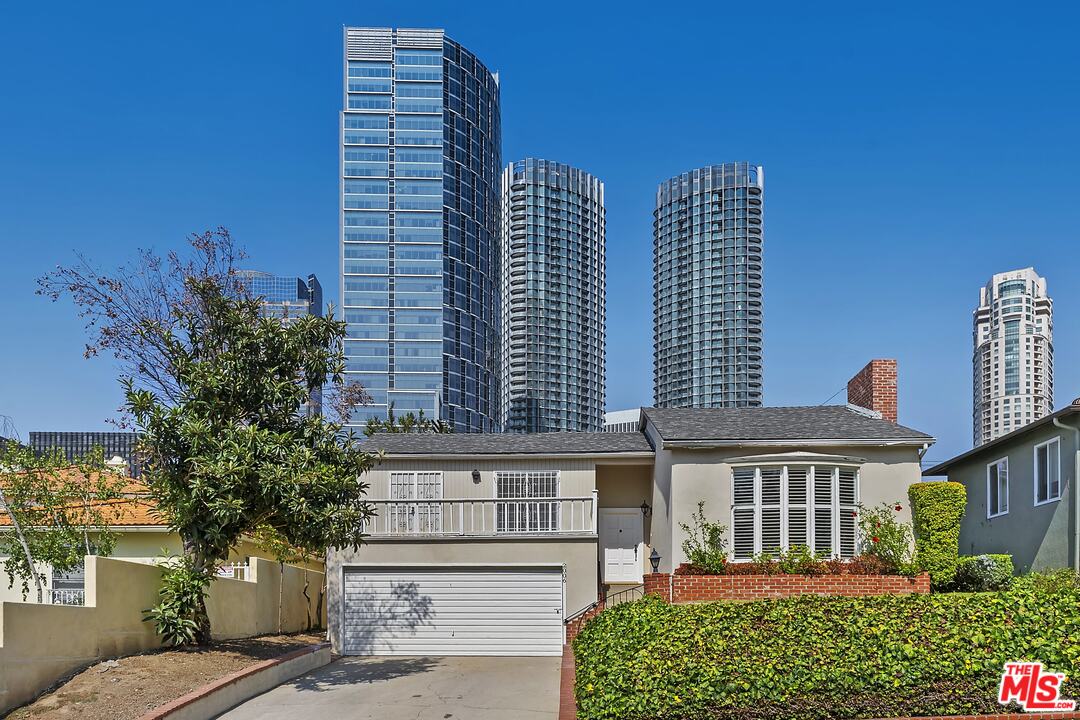 a front view of a residential apartment building with a yard