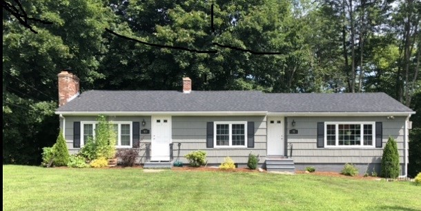 a front view of a house with a yard and porch