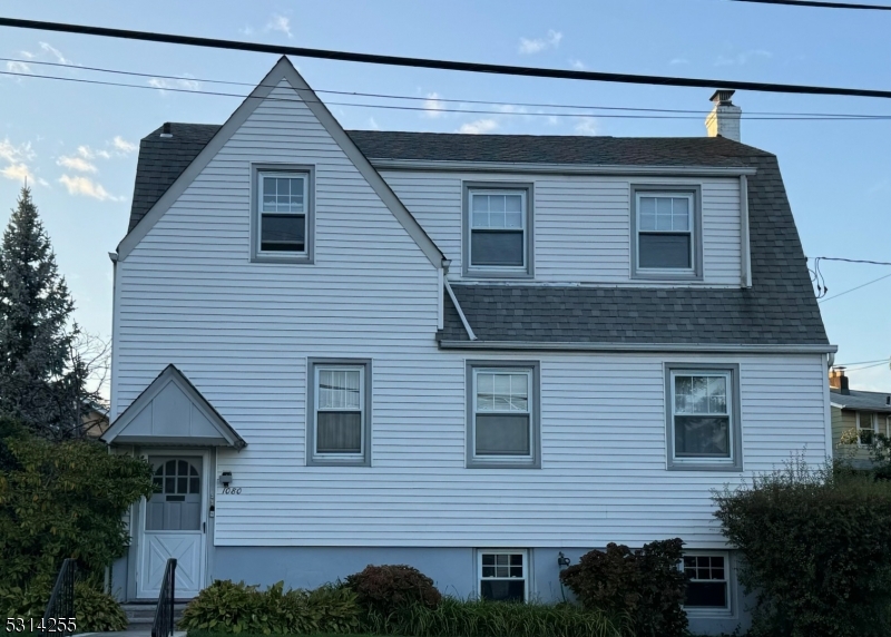 a front view of a house with plants