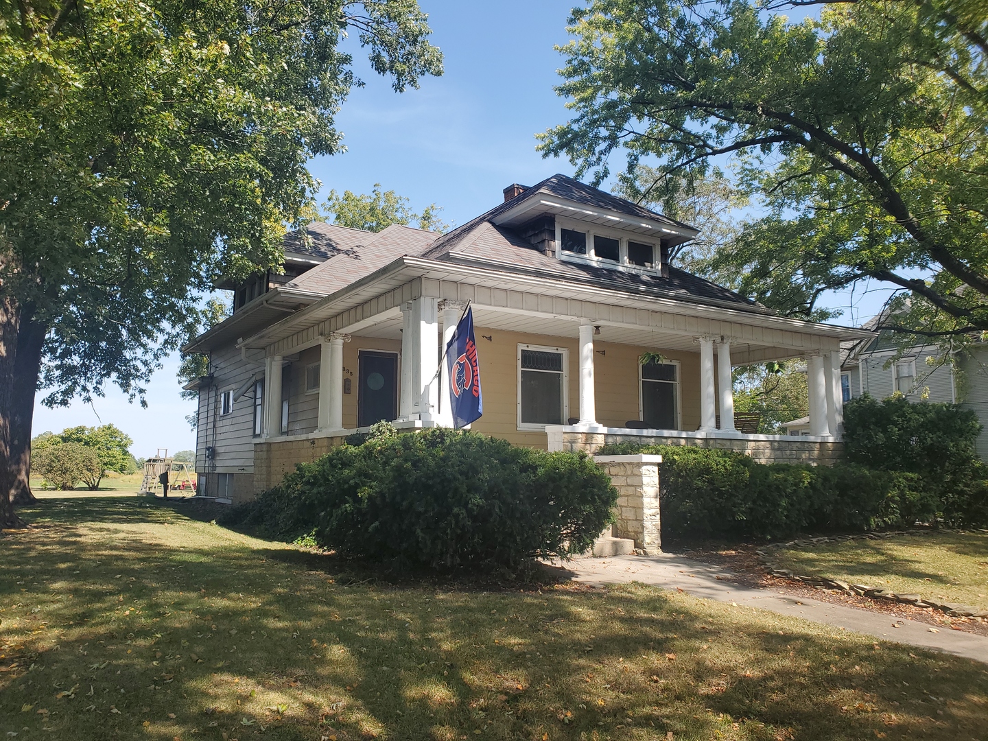 a front view of house with yard and green space