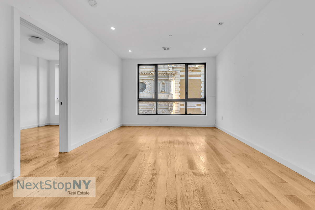 a view of an empty room with glass door