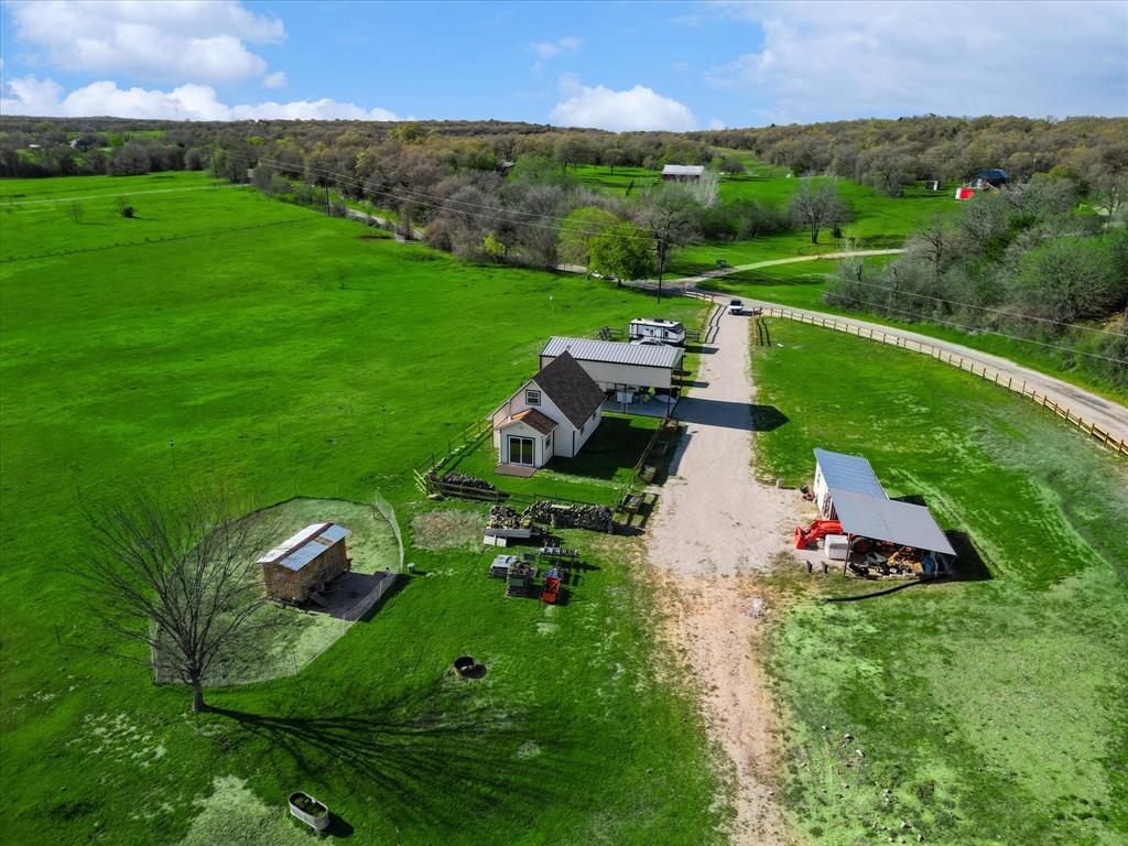 an aerial view of a house with yard