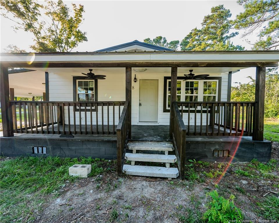 a view of a house with a yard and deck