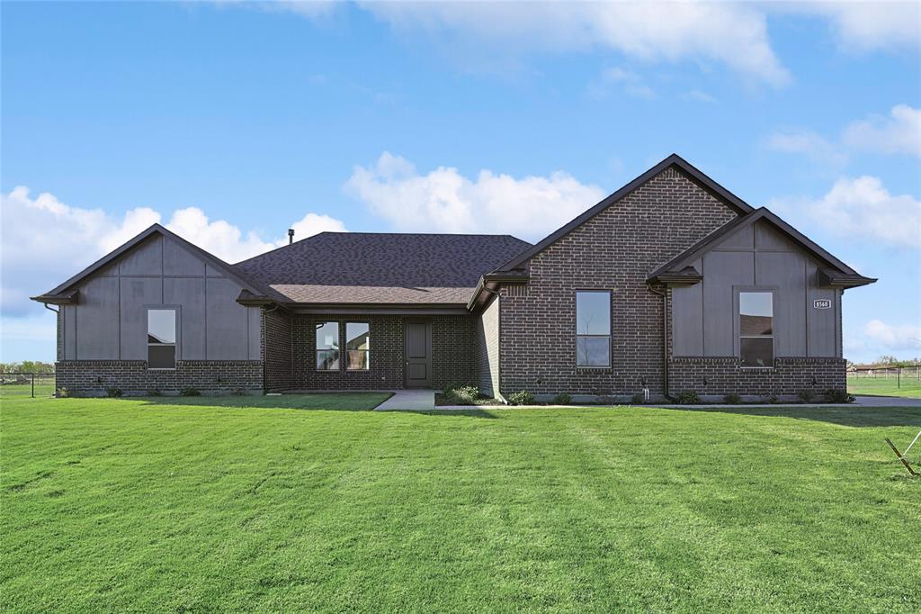 a brick house with a yard