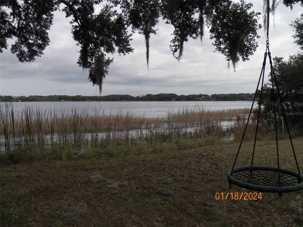 a view of lake with a yard