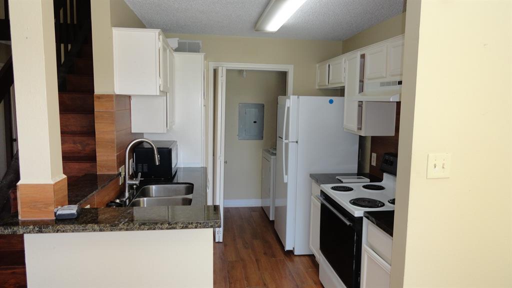 a kitchen with stainless steel appliances granite countertop a refrigerator and a stove