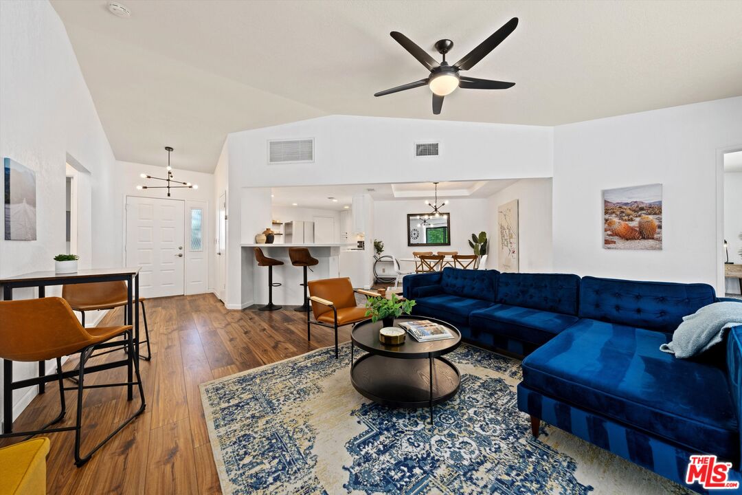 a living room with furniture and wooden floor