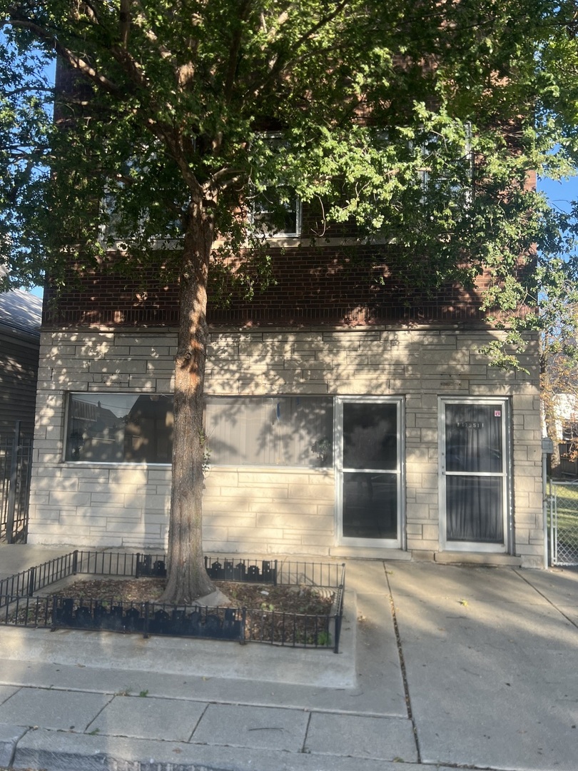 a view of a house with a tree