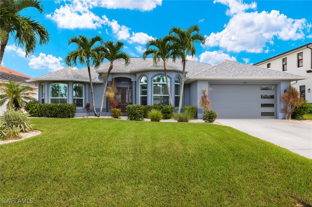 a front view of a house with a garden