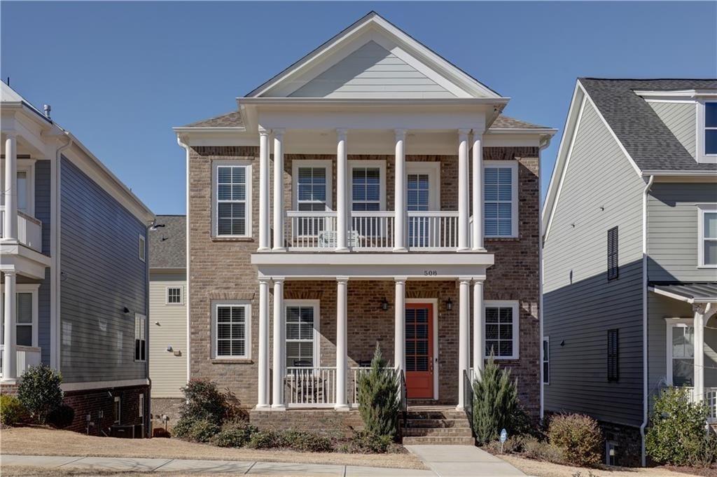 front view of a brick house with a yard