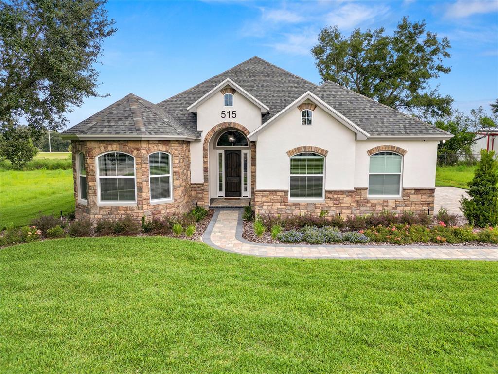 a front view of a house with a yard and garage