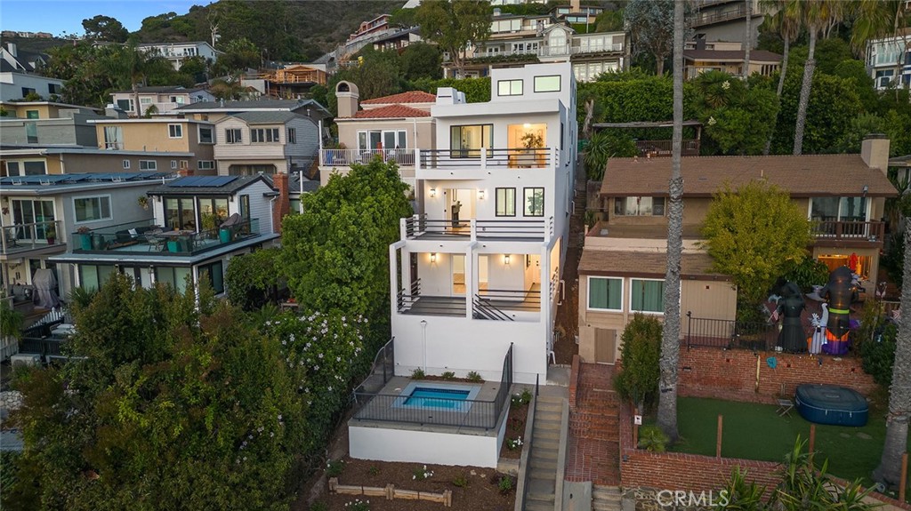 a front view of a house with a yard and balcony