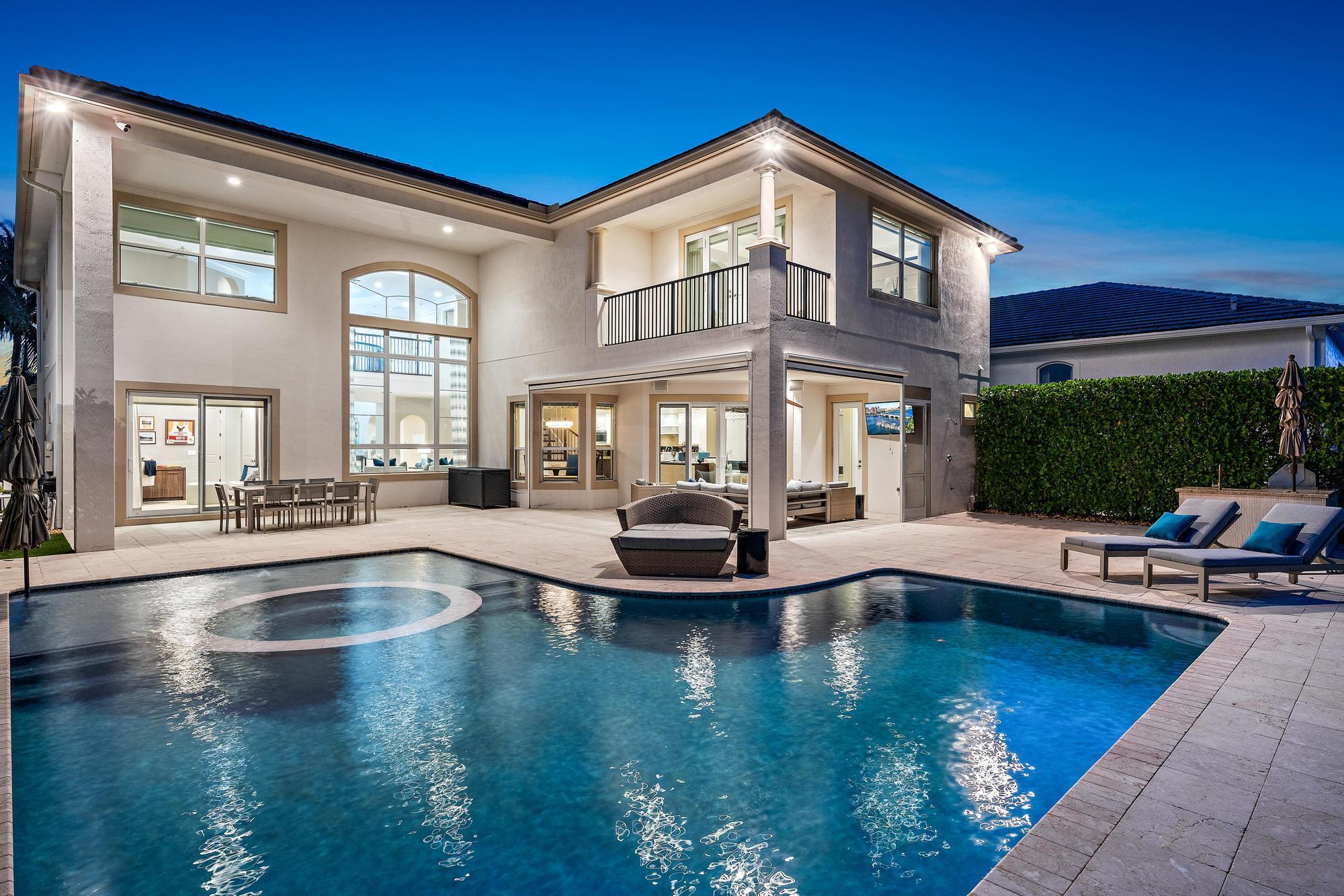 a view of a house with swimming pool and sitting area